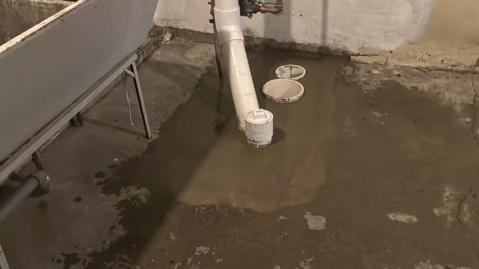 Residential drain piping above standing water in a crawlspace